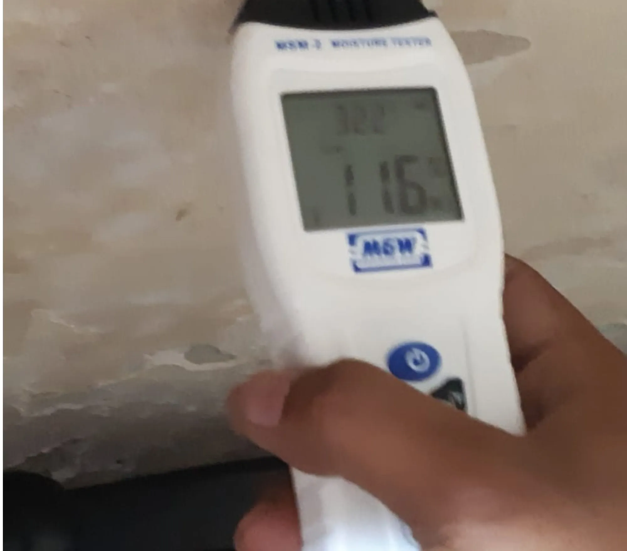 Moisture meter reading taken on a bathroom wall before waterproofing — Mahadev Waterproofing